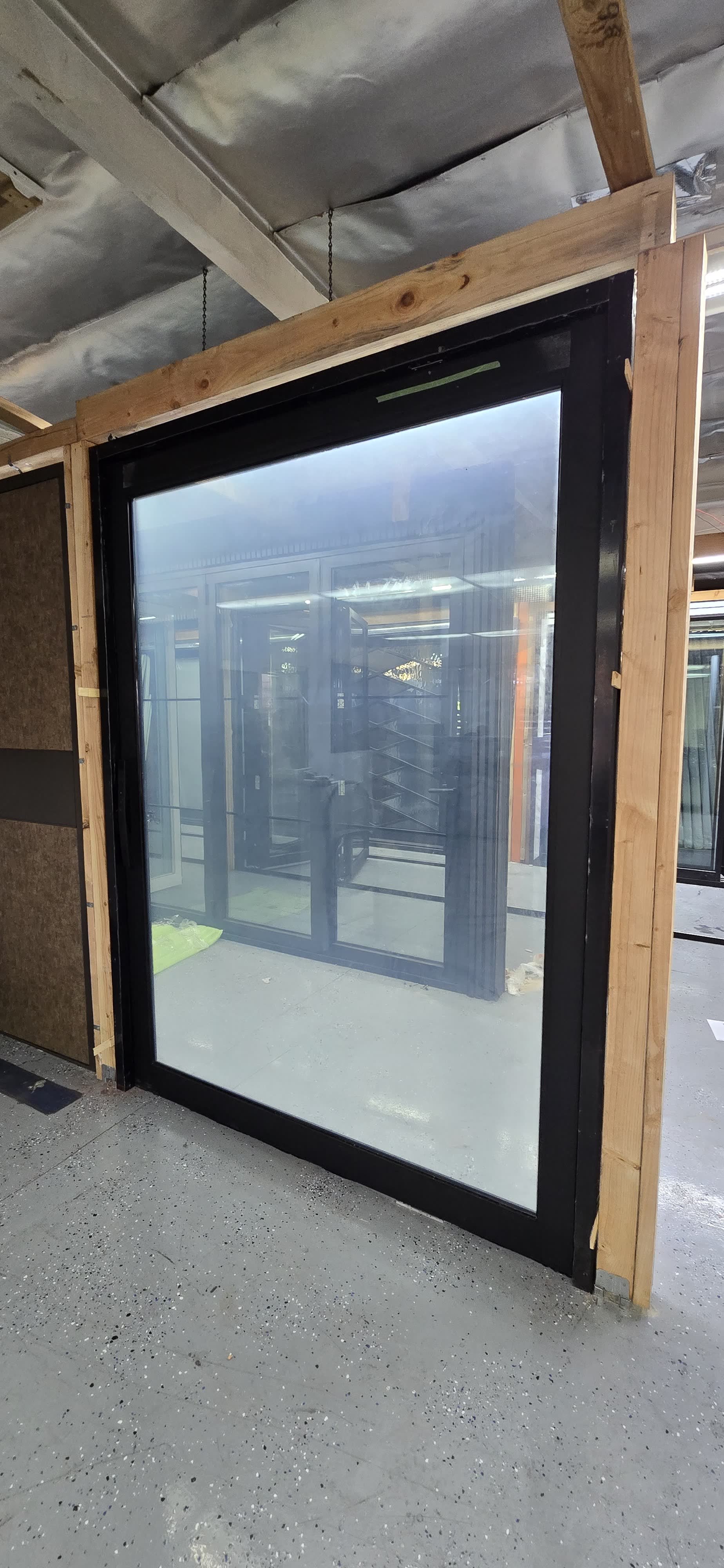 Large fixed aluminum picture window with black frame