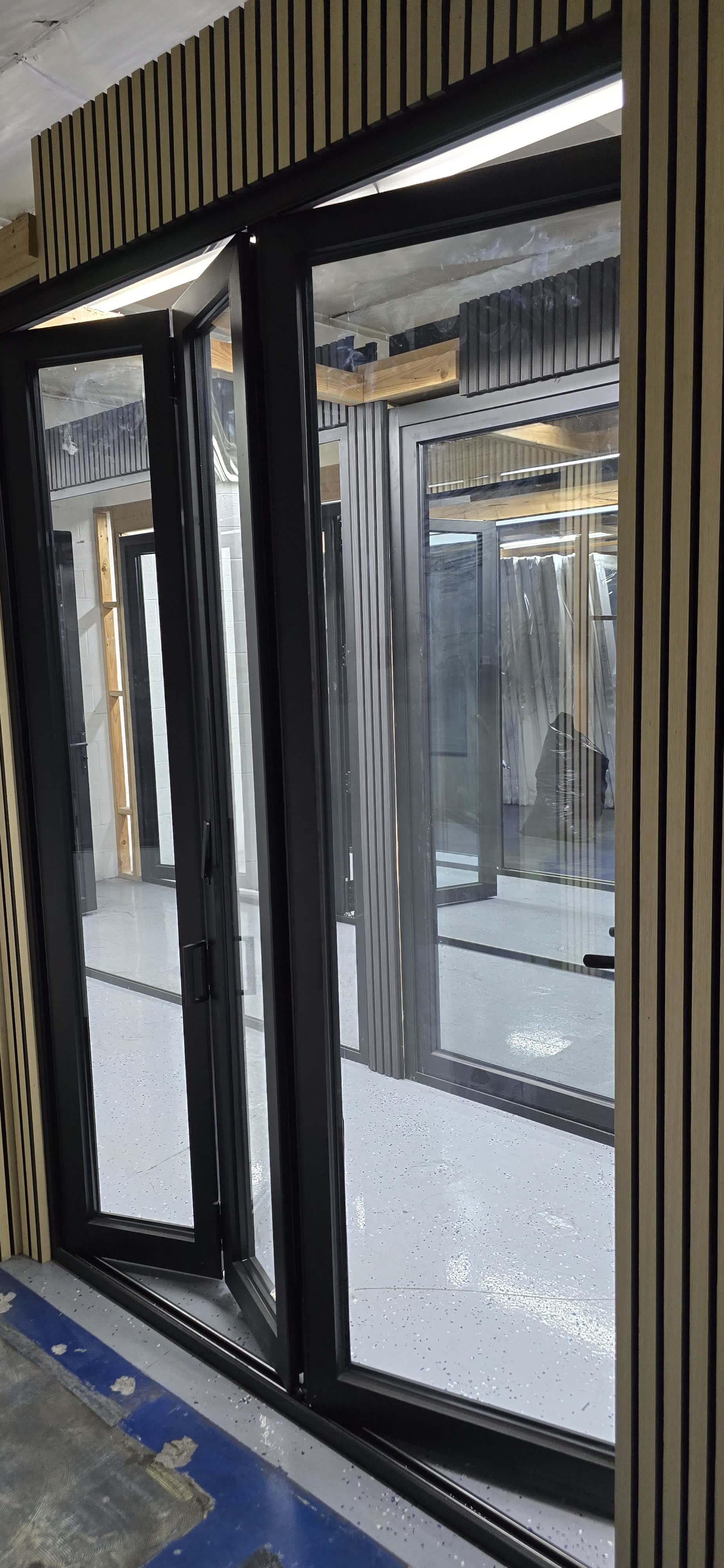 Close-up of aluminum bi-fold door hinge and frame detail