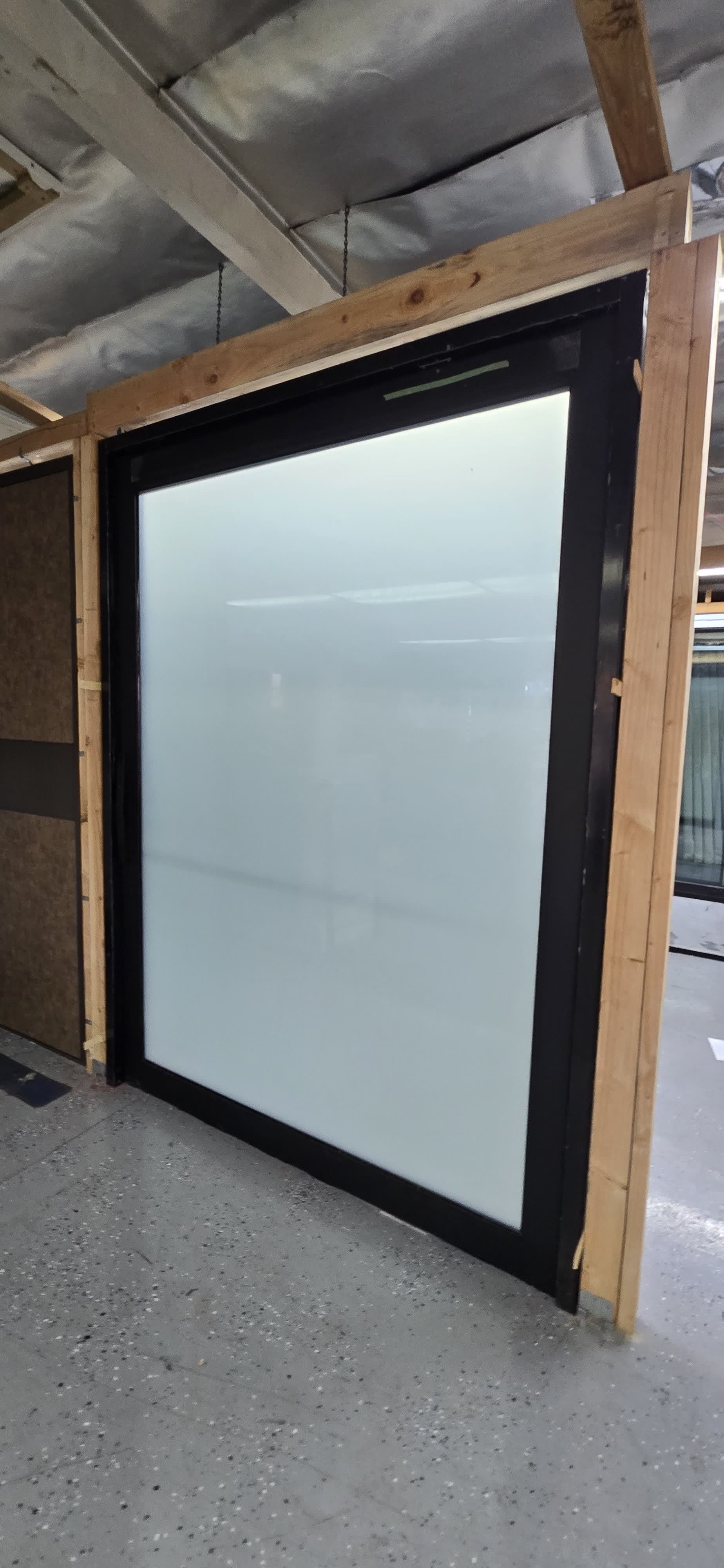 Black-framed aluminum window unit with insulated glazing